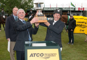 Eric Lamaze raises the trophy with George Lidgett, Executive Vice President of Operations and Manufacturing at ATCO Structures & Logistics. Photo © Spruce Meadows Media Services.  