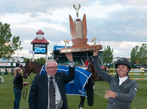   Kent Farrington lifts the trophy for the third year in a row after winning the $33,000 ATB Financial Cup, here with Dave Mowat, President & CEO, ATB Financial. Photo © Spruce Meadows Media Services.