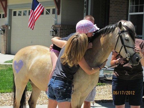 A final goodbye: Friends brought Grace to Avery’s house so she could sit on her pony, feed her carrots, rub her tail, breathe her spirit and say goodbye. Photo courtesy of Vicki Dudasch  