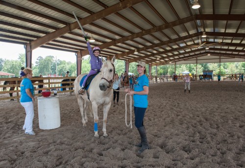 Ainsley Alley on Max prepares for jousting at the All SIRE Horse Show in May 2014. SIRE board member Reneé Adair is leading Max. Photo by Jaana Eleftheriou  