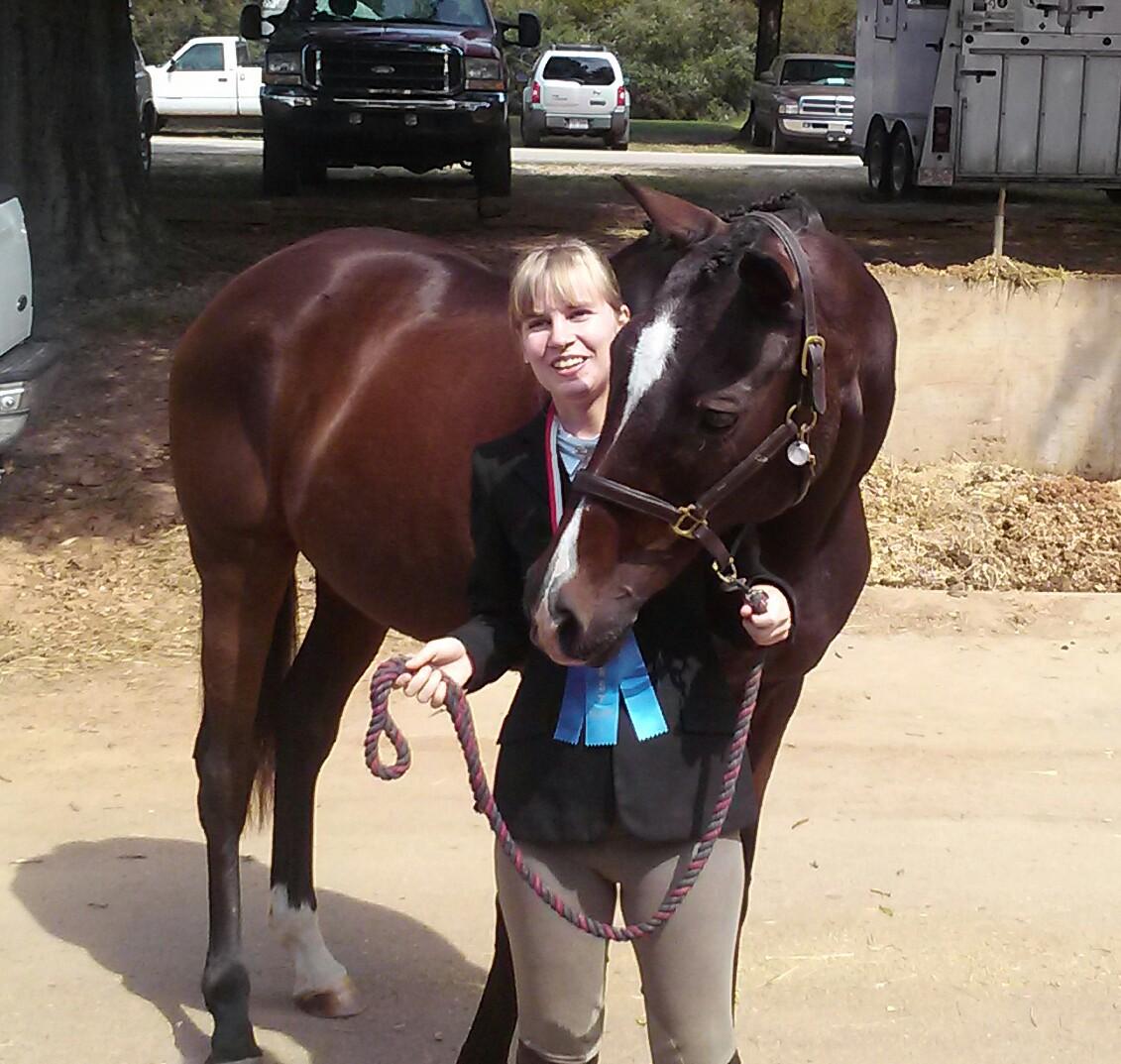 Lina and Ruby posing with a medal and ribbon they earned at the 2014 Special Olympics North Carolina Equestrian Tournament. (Photo by Tracy Franklin)