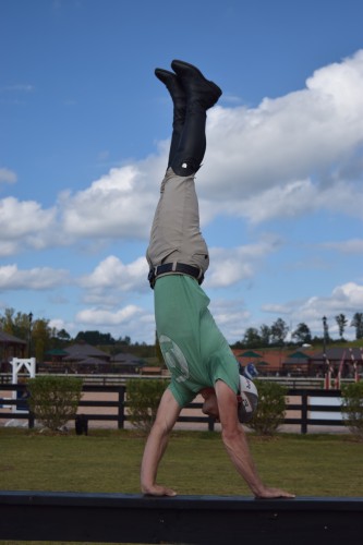 Josh Dolan can ride and rescue minis, but he can also do a handstand on a fence!
