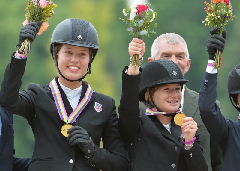 Jennifer joyously dons her gold medal with her team at the 2014 North American Young Rider Championships. Photo courtesy of JKG Farms 