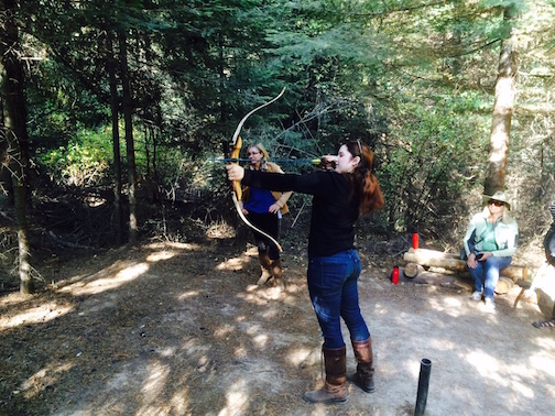 Abby Westmark tries her hand at archery. Photo by Jan Westmark