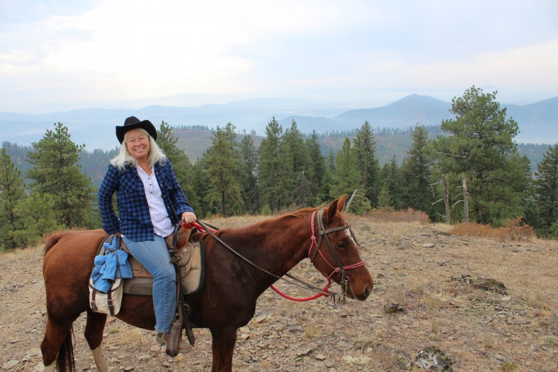 Maureen Dorsey enjoys time in the saddle — and a view — at Red Horse Mountain Ranch. Photo by Anne Joubert