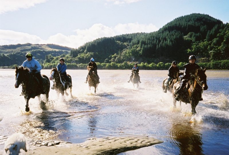 Cathy (second on right) and her fellow travelers gallop along the shore of Loch Fyne, longest of the sea lochs, the name meaning loch or lake of wine or vine and known for its oyster fisheries