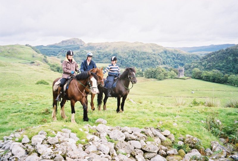 Cathy, left, Peter from Ireland, and Jane from Scotland were privileged to ride across the estate lands of 18th century Stonefield Castle (in background)