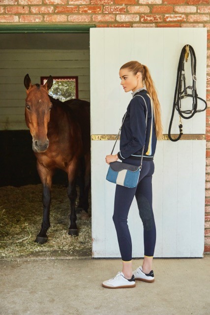 Outfit: Team Jacket in navy and The C Breeches in navy by Callidae available at callidae.com Bag: Oughton, Paddock Crossbody Clutch in turquoise available at www.oughtonlimited.com Shoes: Isabel Marant Etoile, Bryce Sneakers available at FWRD.com