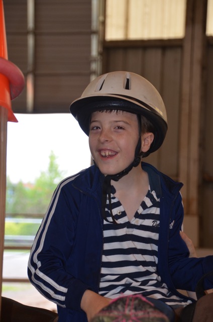 A young rider enjoys riding at the Buffalo Therapeutic Riding Center