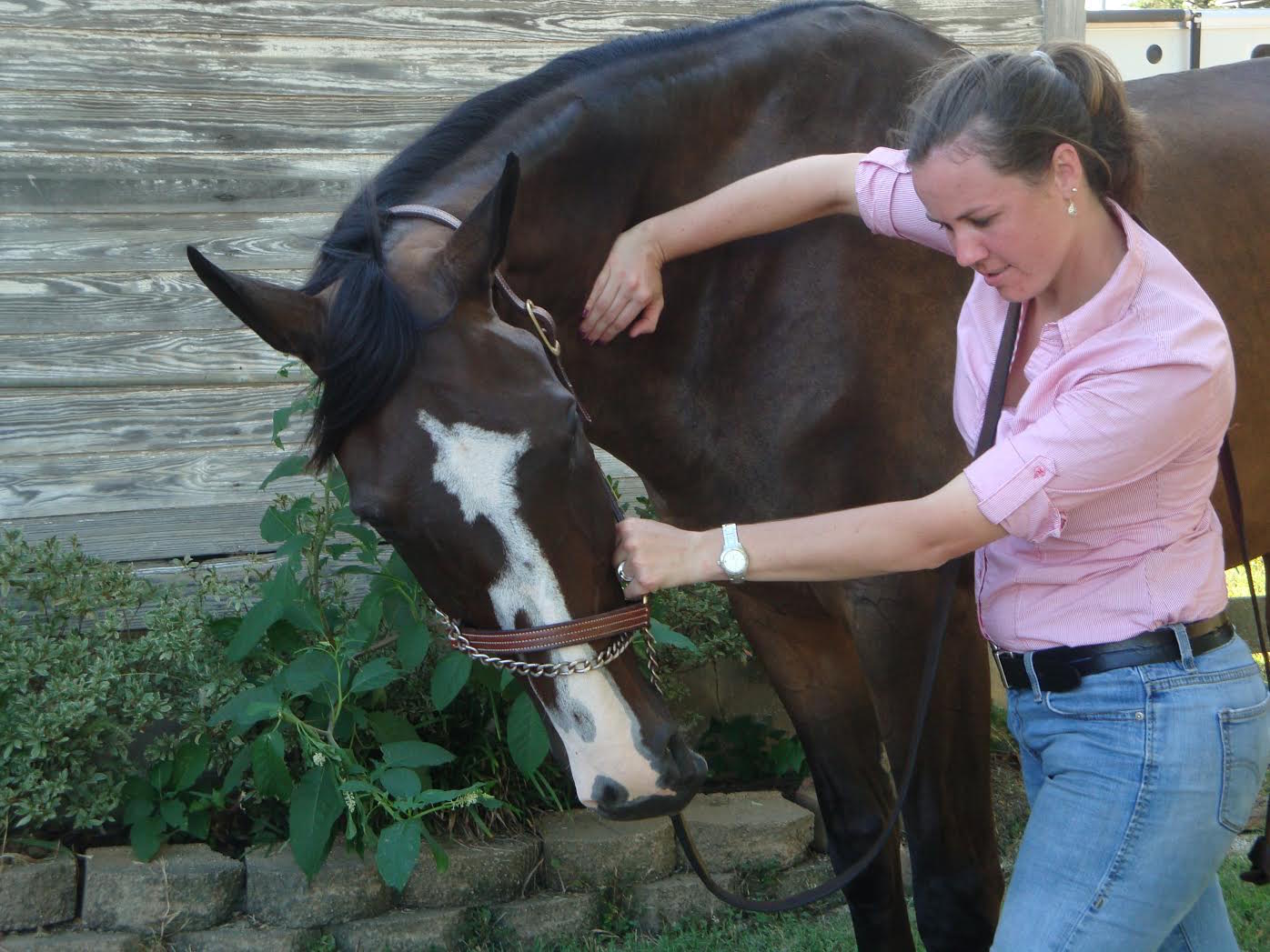 Grace adjusting her sister's horse, By The Book Photo courtesy of Grace Buchanan