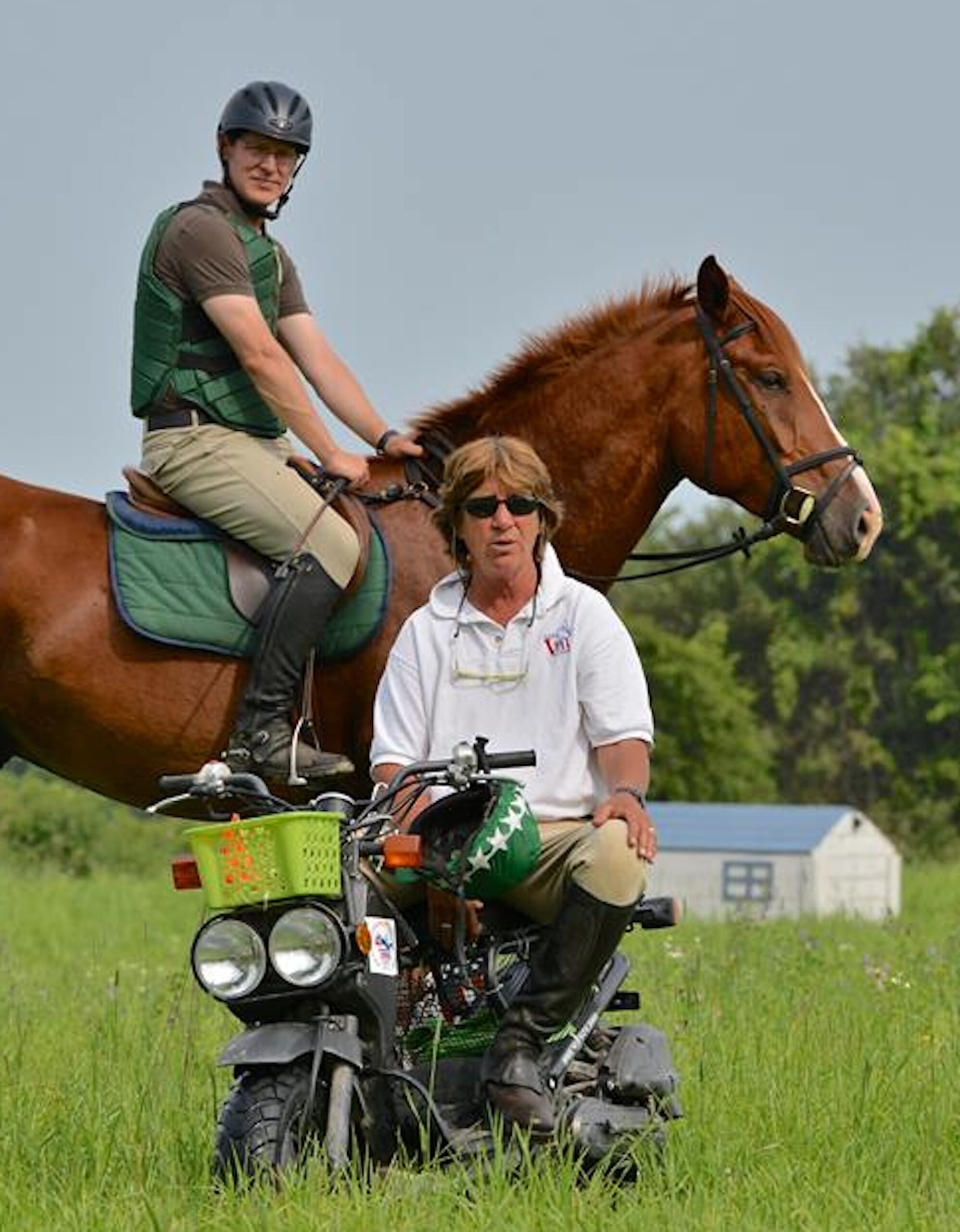 Cathy teaching on the cross-country course at Sprucehaven Farm, Canada, during her 2014 eventing clinic. Participant Andrew Pocock stands by. (Photo by Ian Woodley)