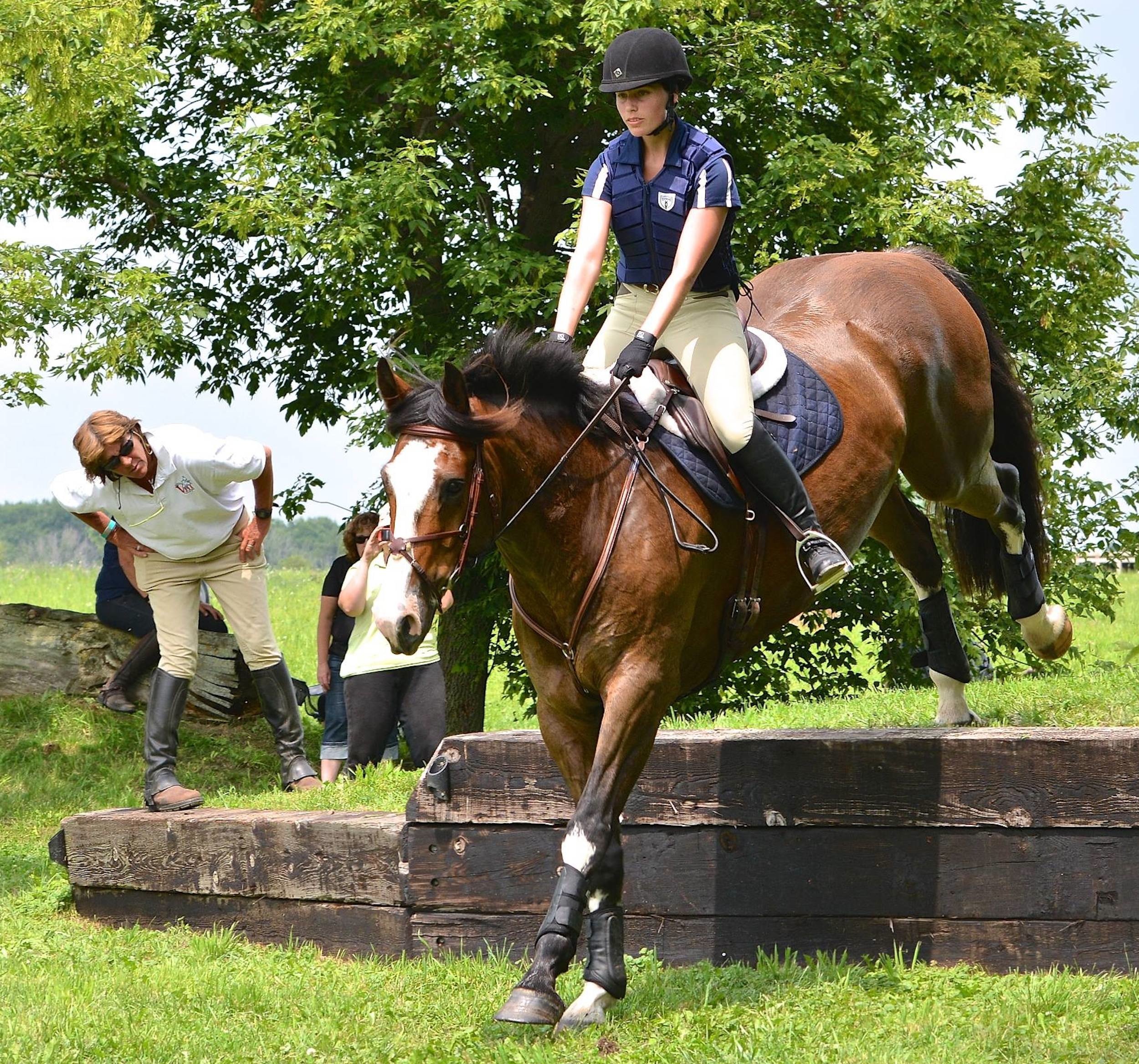 Cathy watches closely as a rider in Sprucehaven Farm’s 2014 eventing clinic (Canada) negotiates a drop. (Photo by Ian Woodley)