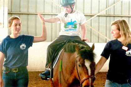 A volunteer gets a high five from a rider.