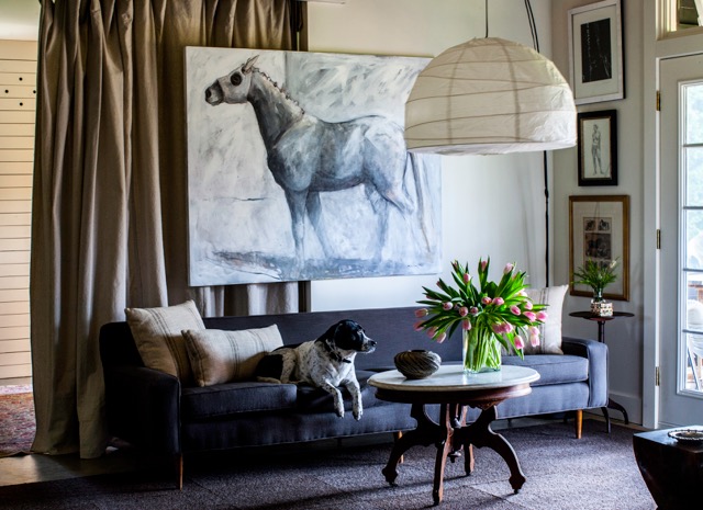 The living room in Lida’s home — which is connected to her two-stall barn — reflects her love for horses. Photo by Kris Kendrick