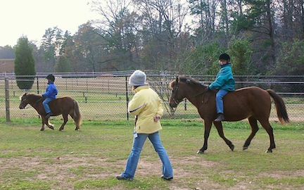 Jamie and Nicole in the early days, taking lessons on their ponies.