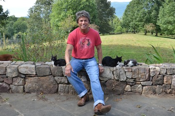 Rita Mae enjoys a few moments with some of her feline friends. In her newest novel, The Litter of the Law, Rita Mae collaborates with feline co-author Sneaky Pie Brown. Photo courtesy of Rita Mae Brown