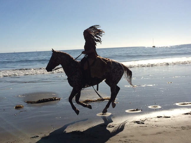 Kerstie gallops down the beach during a photo shoot.