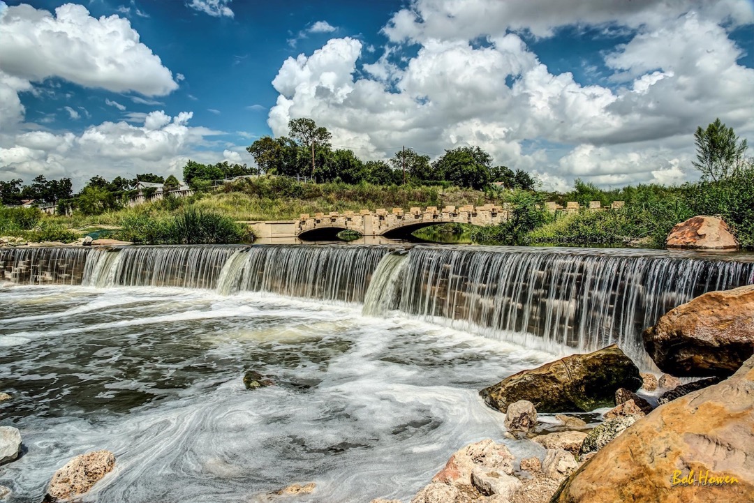 The River Walk includes beautiful stone bridges and waterfalls. Photo courtesy of <a href=