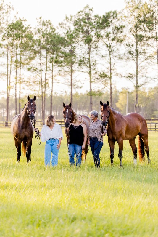 Amy shares a special moment with her daughters, Emily and Jessica, alongside their horses Cody 131, Cascayal Z and Checkpoint 35.